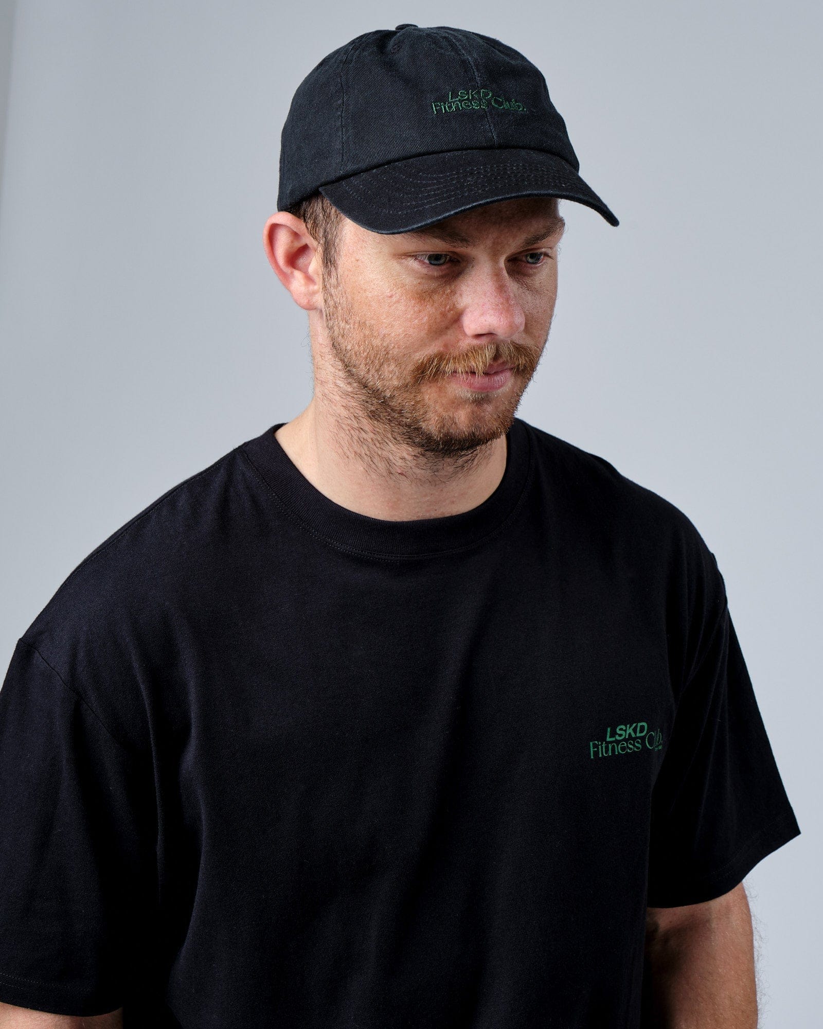 Model wearing Social Cap - Washed Black-Eden Green