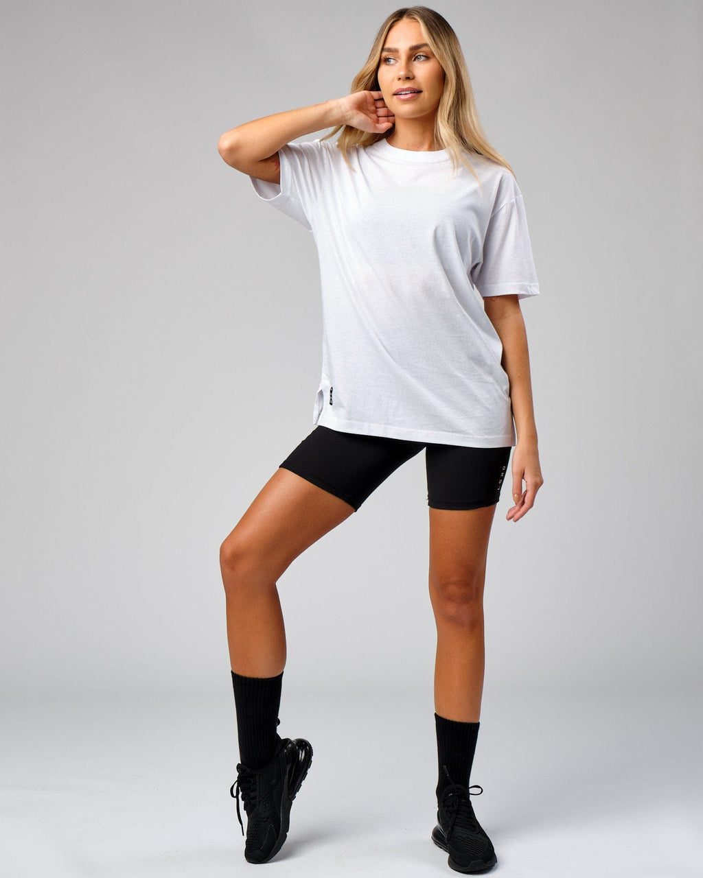 Model wearing Unisex Span Tee Oversize - White