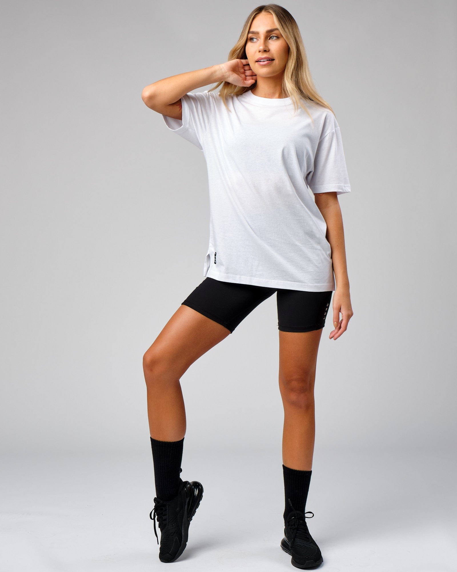Model wearing Unisex Span Tee Oversize - White
