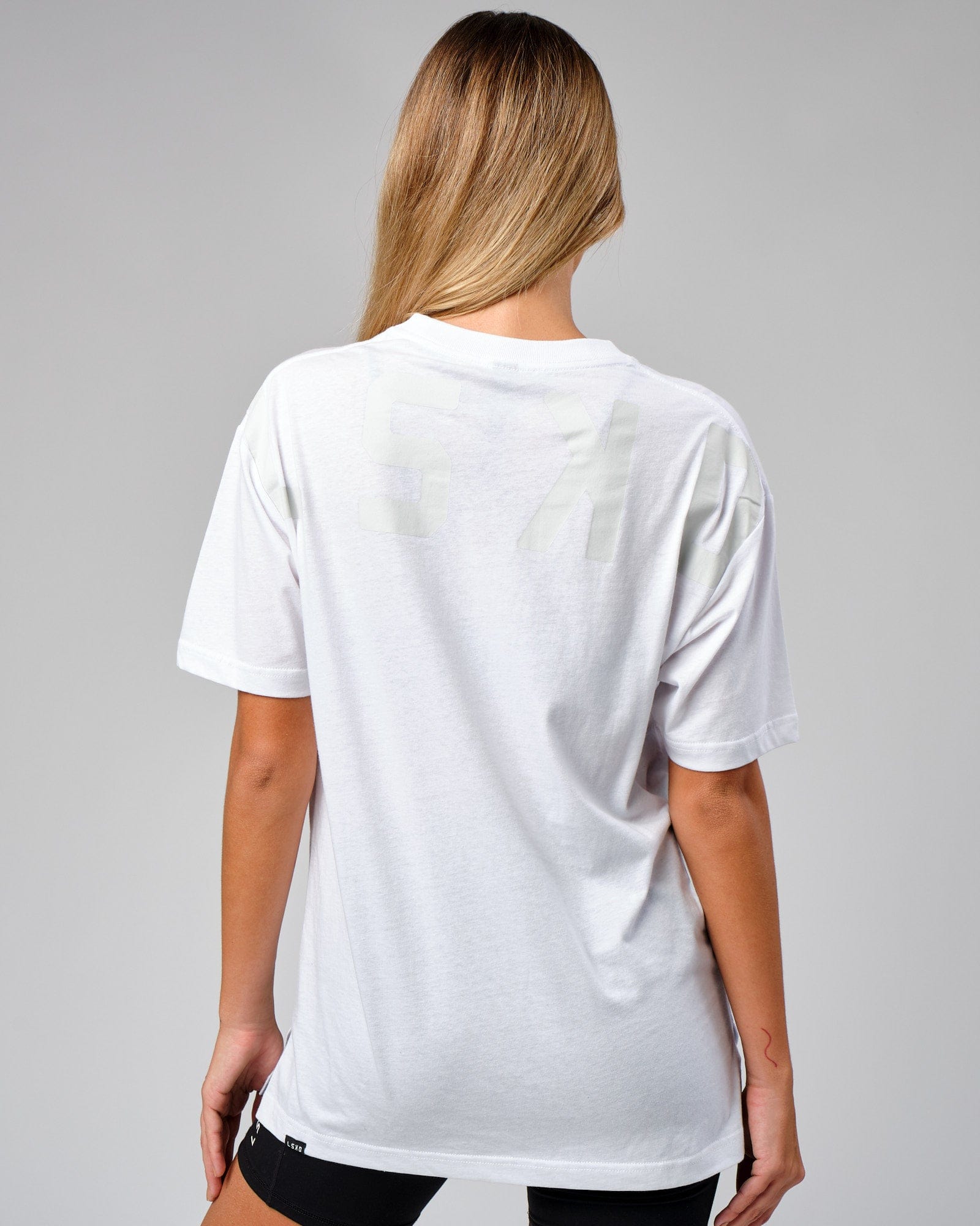 Model wearing Unisex Span Tee Oversize - White