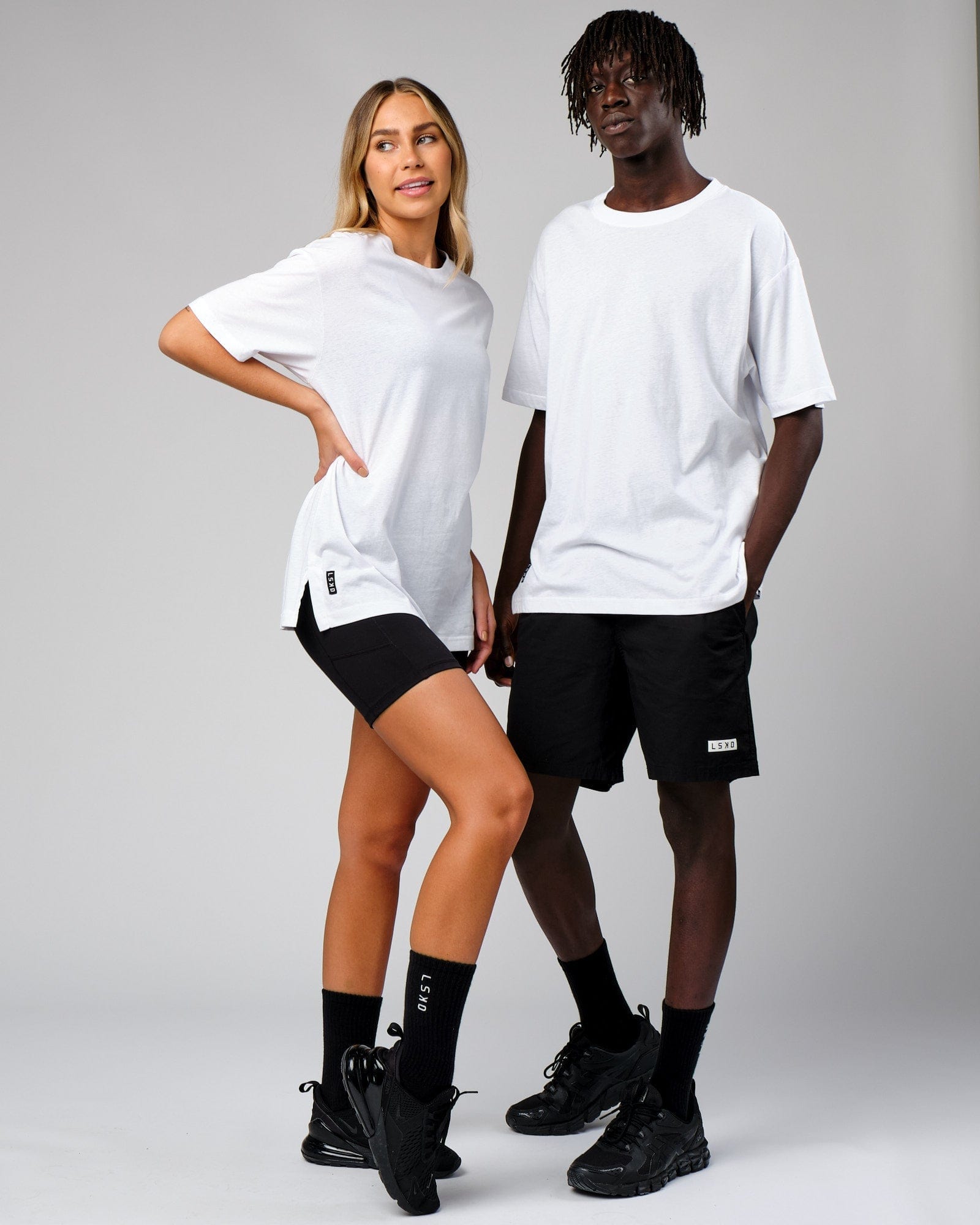 Model wearing Unisex Span Tee Oversize - White