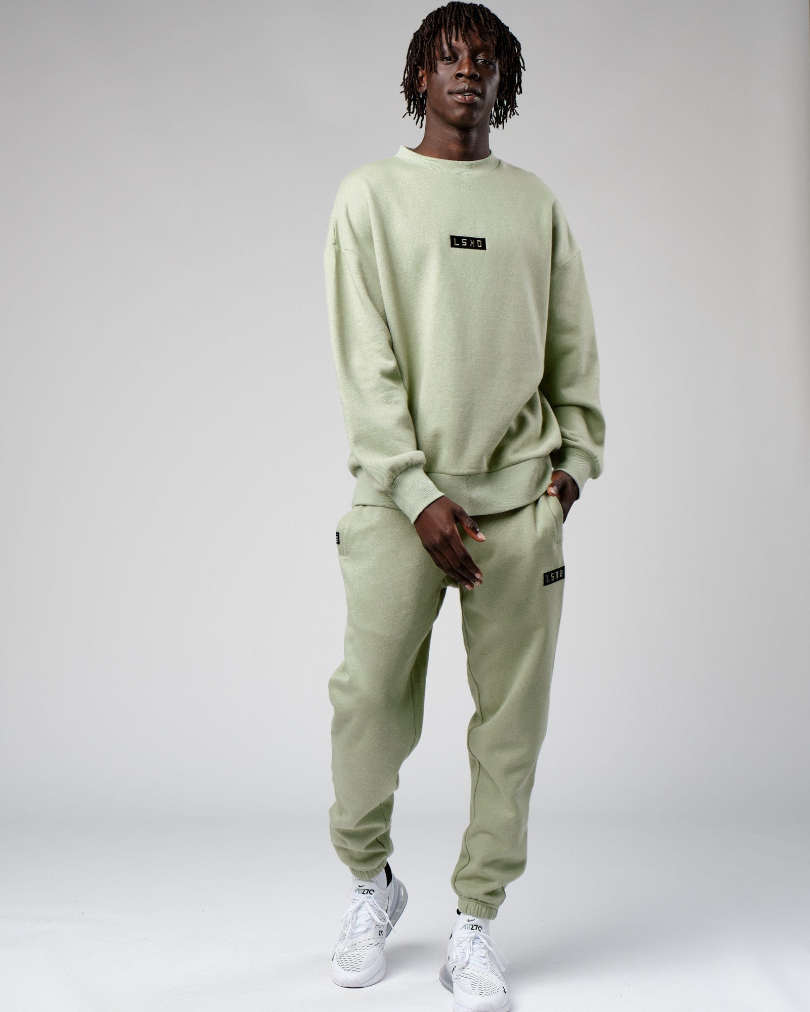 Model wearing Cornerstone Track Pant Oversize - Desert Sage