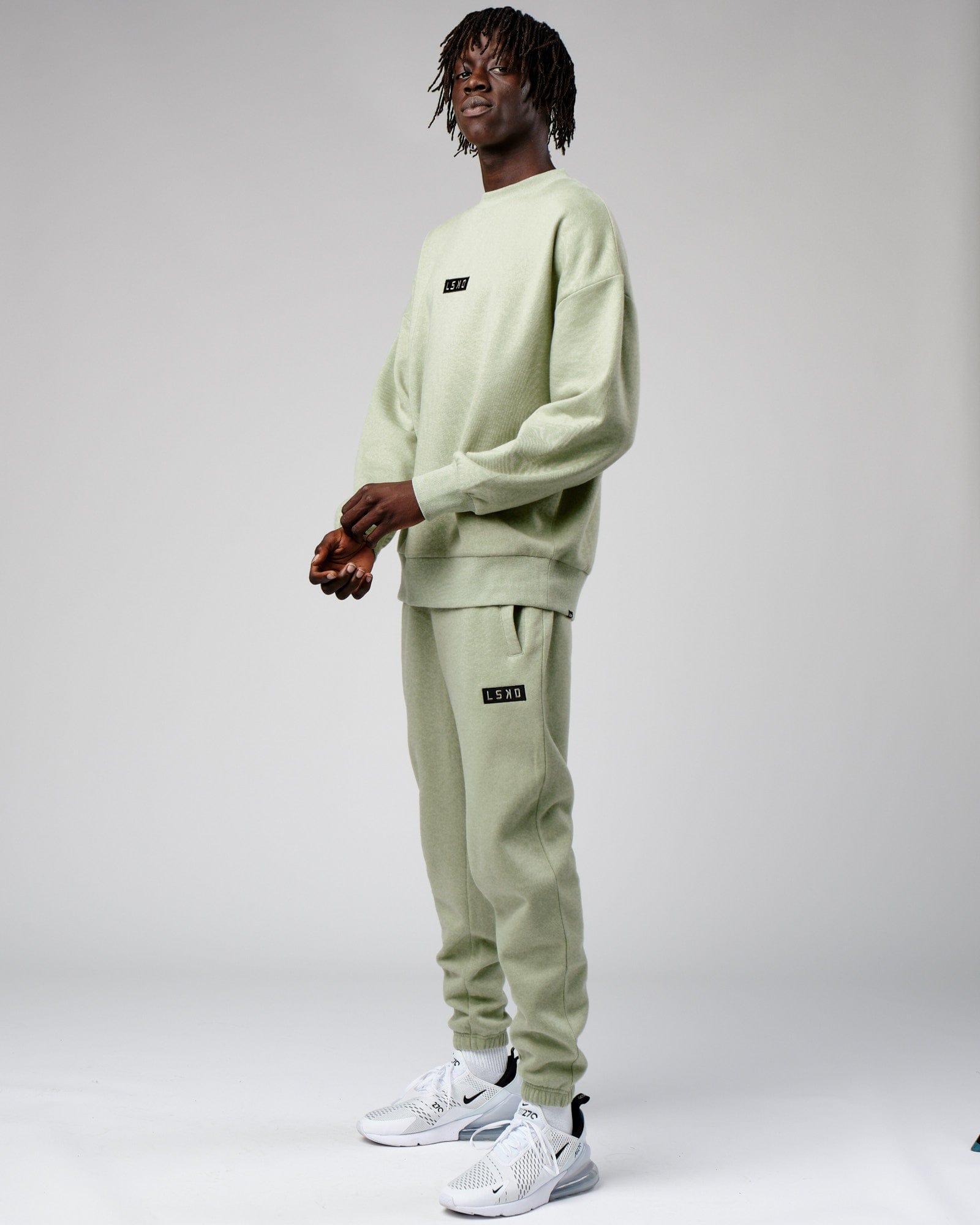 Model wearing Cornerstone Track Pant Oversize - Desert Sage