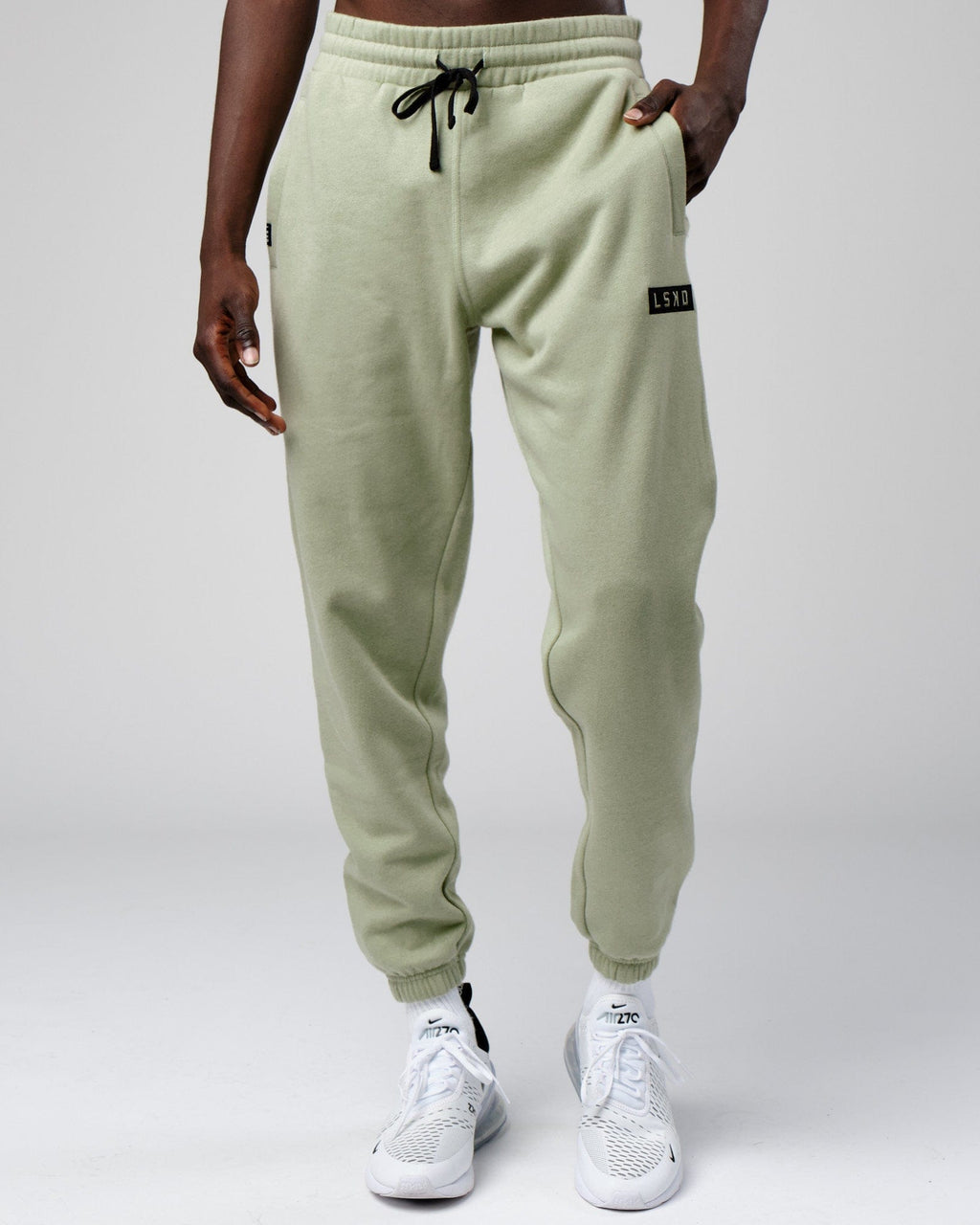 Model wearing Cornerstone Track Pant Oversize - Desert Sage