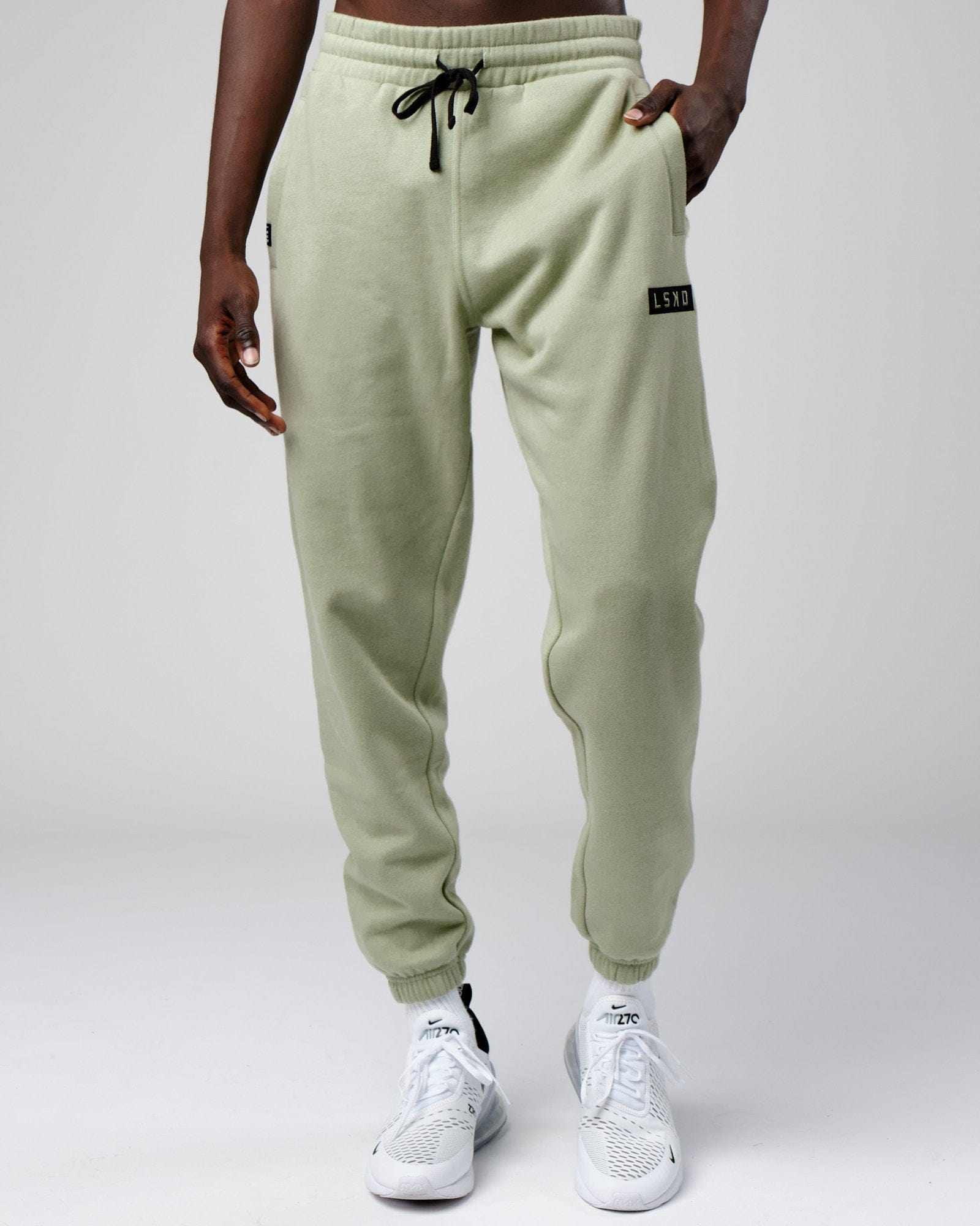 Model wearing Cornerstone Track Pant Oversize - Desert Sage