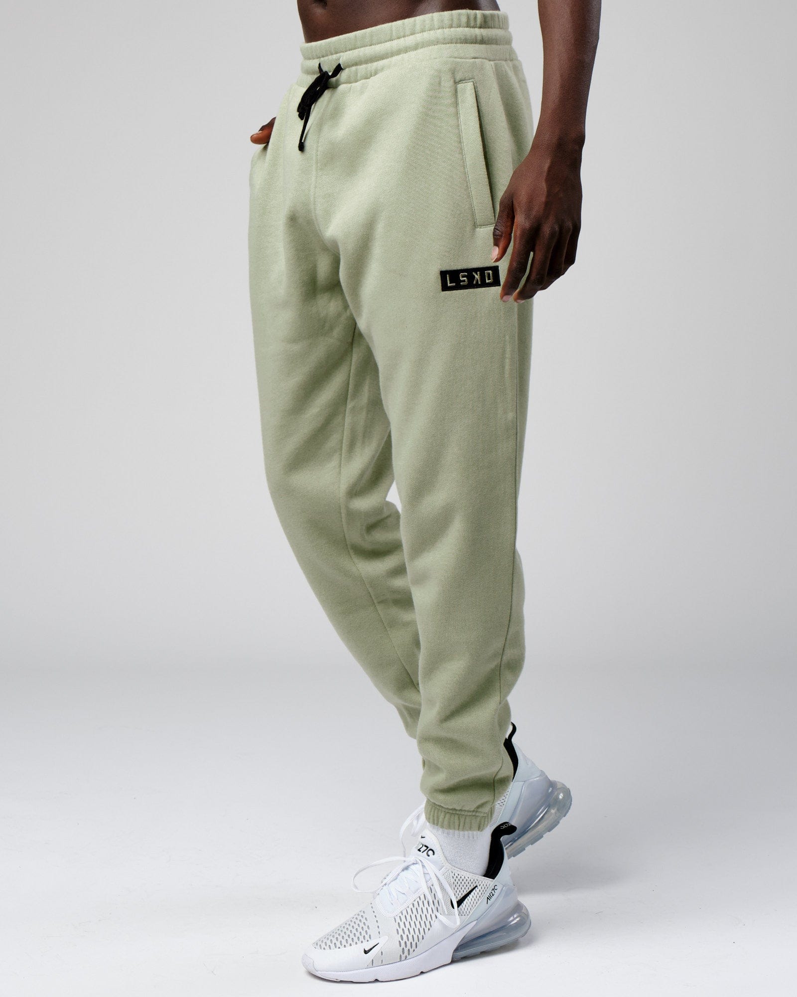 Model wearing Cornerstone Track Pant Oversize - Desert Sage