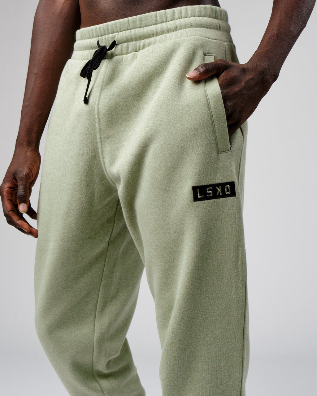 Model wearing Cornerstone Track Pant Oversize - Desert Sage
