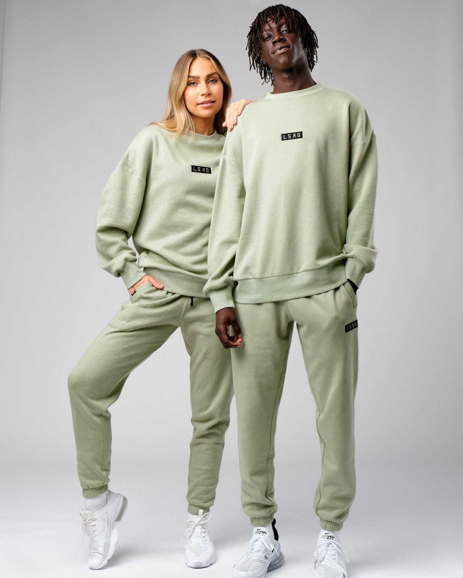 Model wearing Unisex Cornerstone Track Pant Oversize - Desert Sage