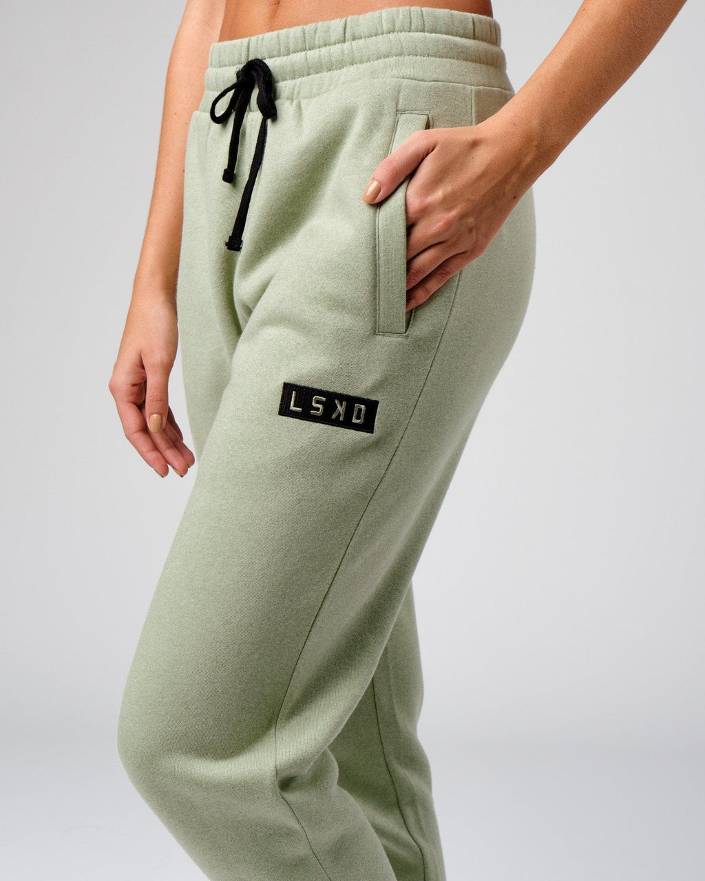 Model wearing Unisex Cornerstone Track Pant Oversize - Desert Sage