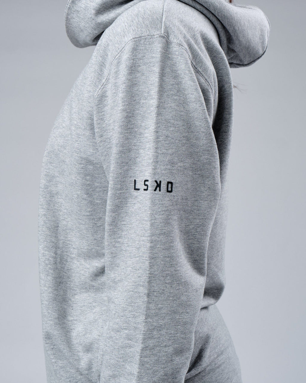 Model wearing Unisex Rival FLXFleece Training Fit Hoodie - Lt Grey Marl