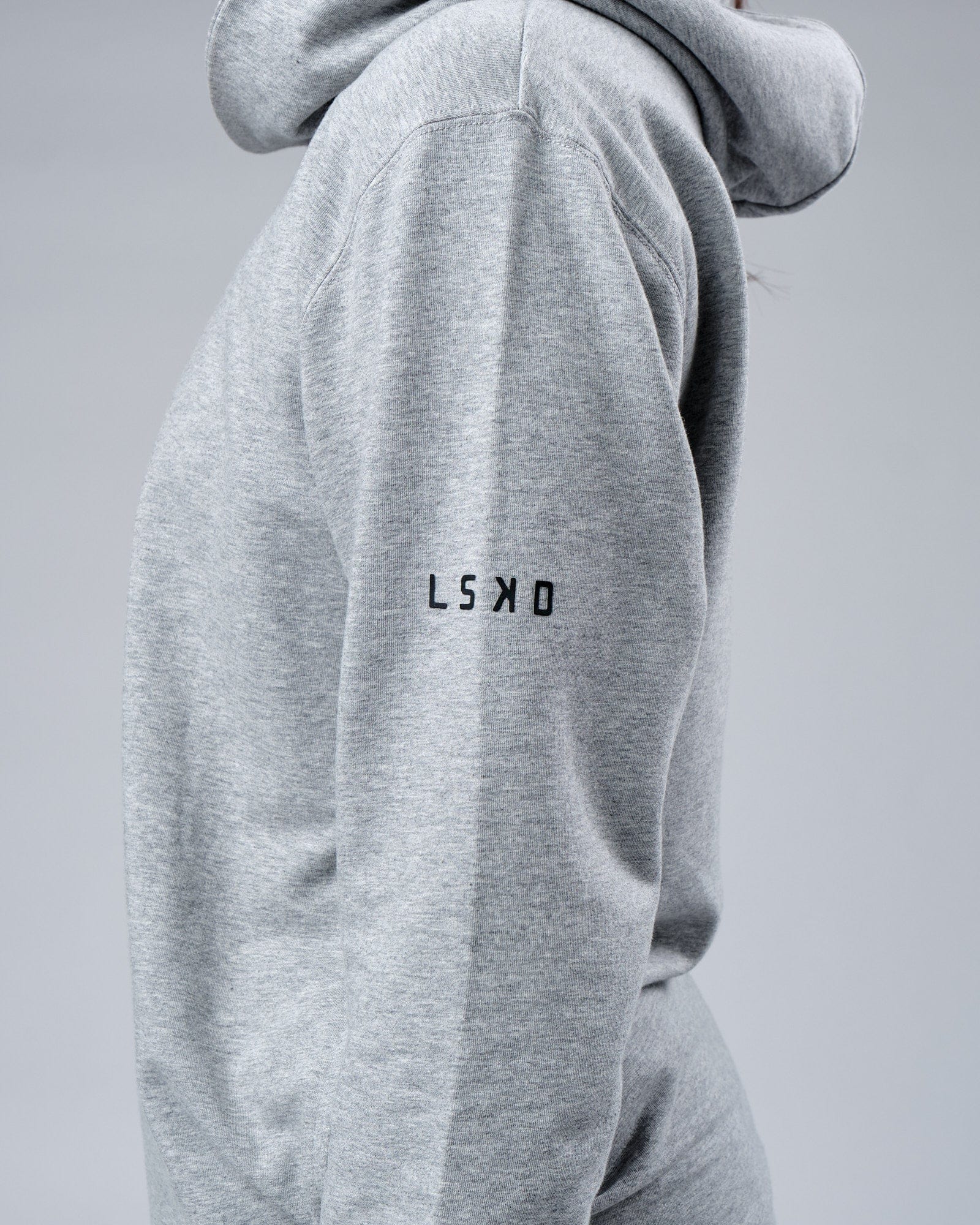 Model wearing Unisex Rival FLXFleece Training Fit Hoodie - Lt Grey Marl