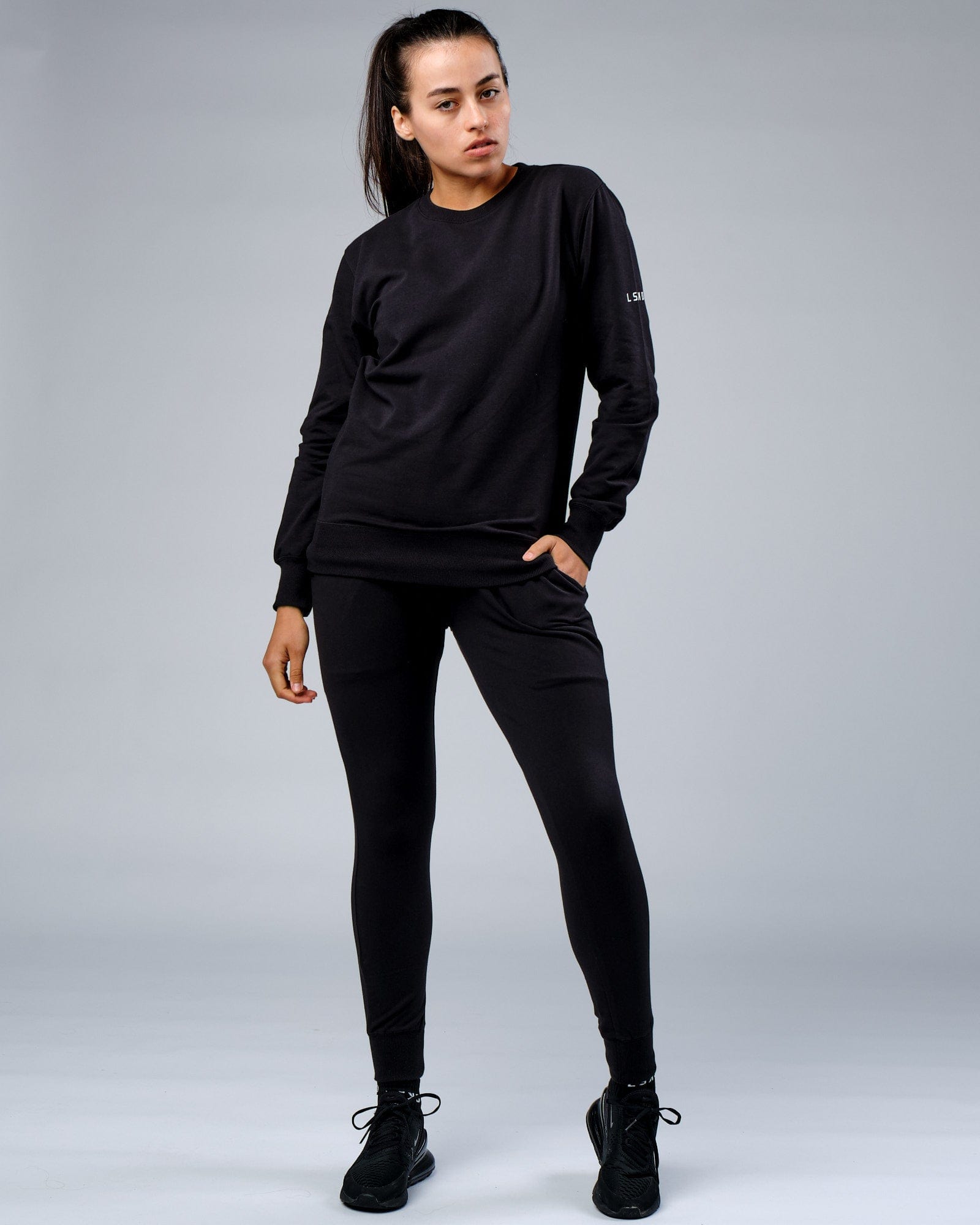 Model wearing Unisex Rival FLXFleece Track Pant - Black