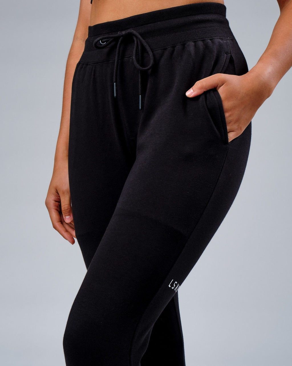 Model wearing Unisex Rival FLXFleece Track Pant - Black