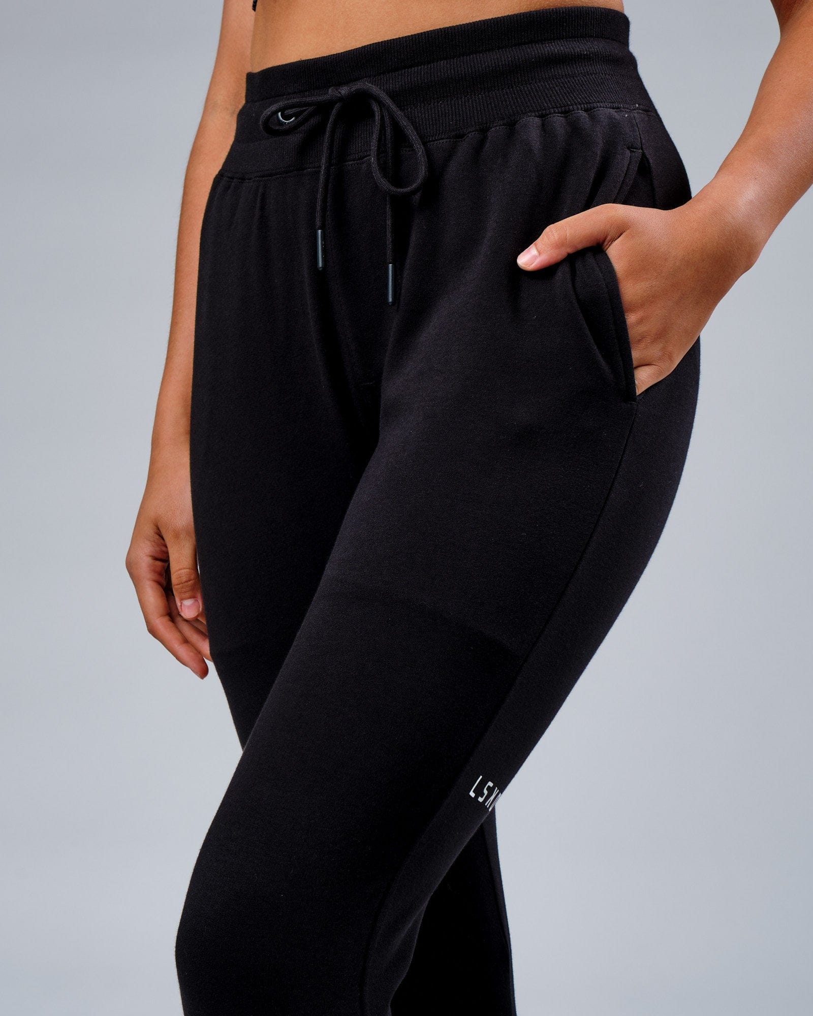 Model wearing Unisex Rival FLXFleece Track Pant - Black
