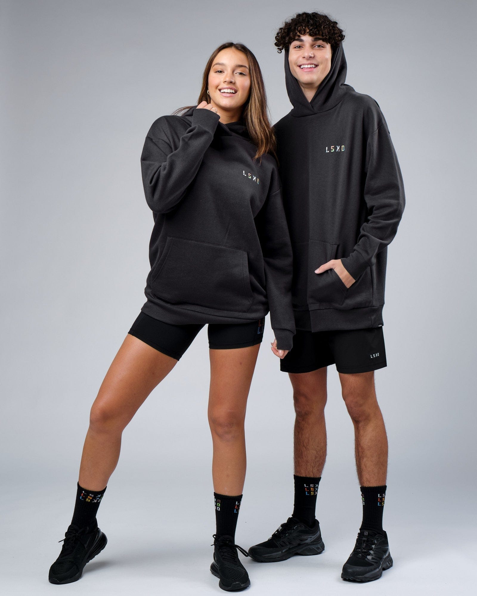 Model wearing Unisex Unity Hoodie Oversize - Pirate Black