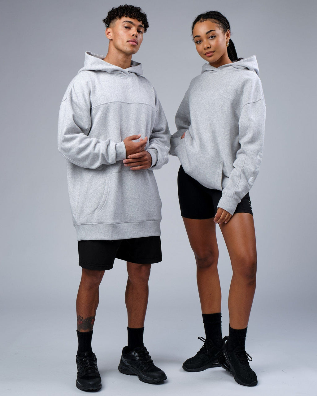 Model wearing Unisex Zone Hoodie Oversize - Lt Grey Marl