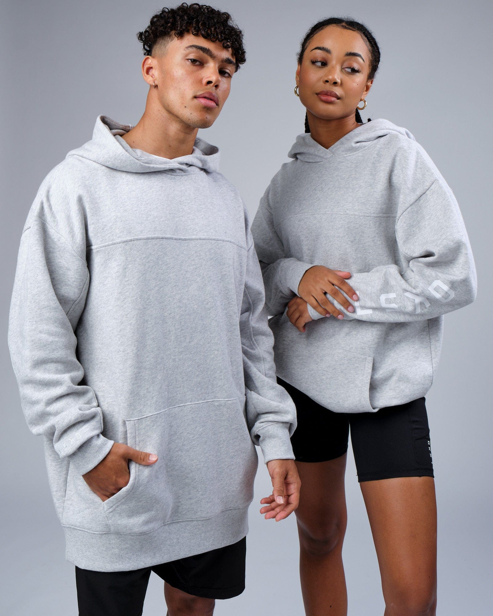 Model wearing Unisex Zone Hoodie Oversize - Lt Grey Marl