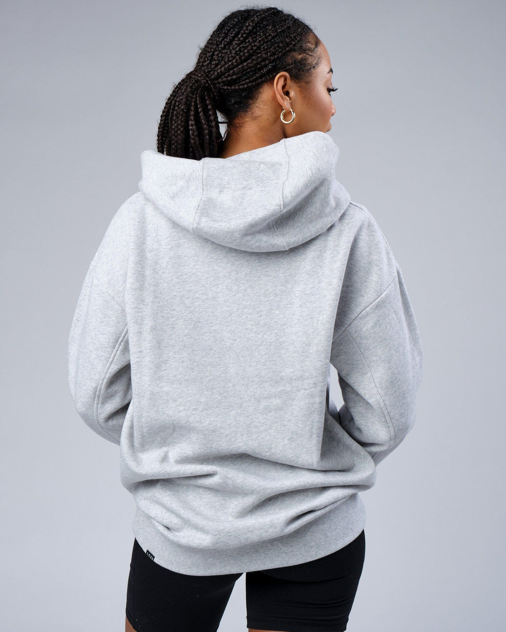 Model wearing Unisex Zone Hoodie Oversize - Lt Grey Marl
