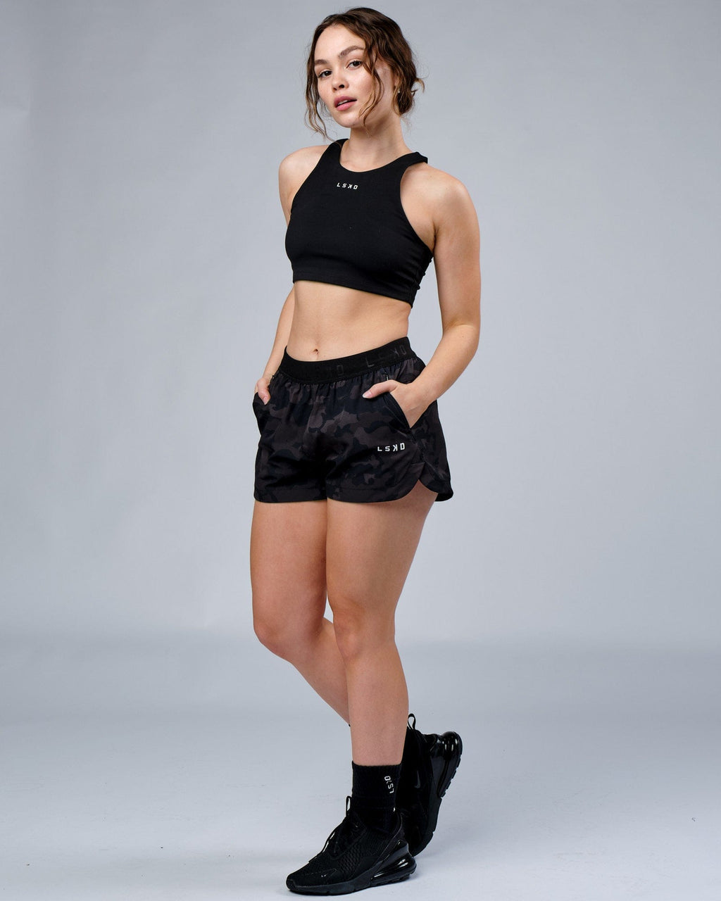 Model wearing Competition Performance Short - Black Camo