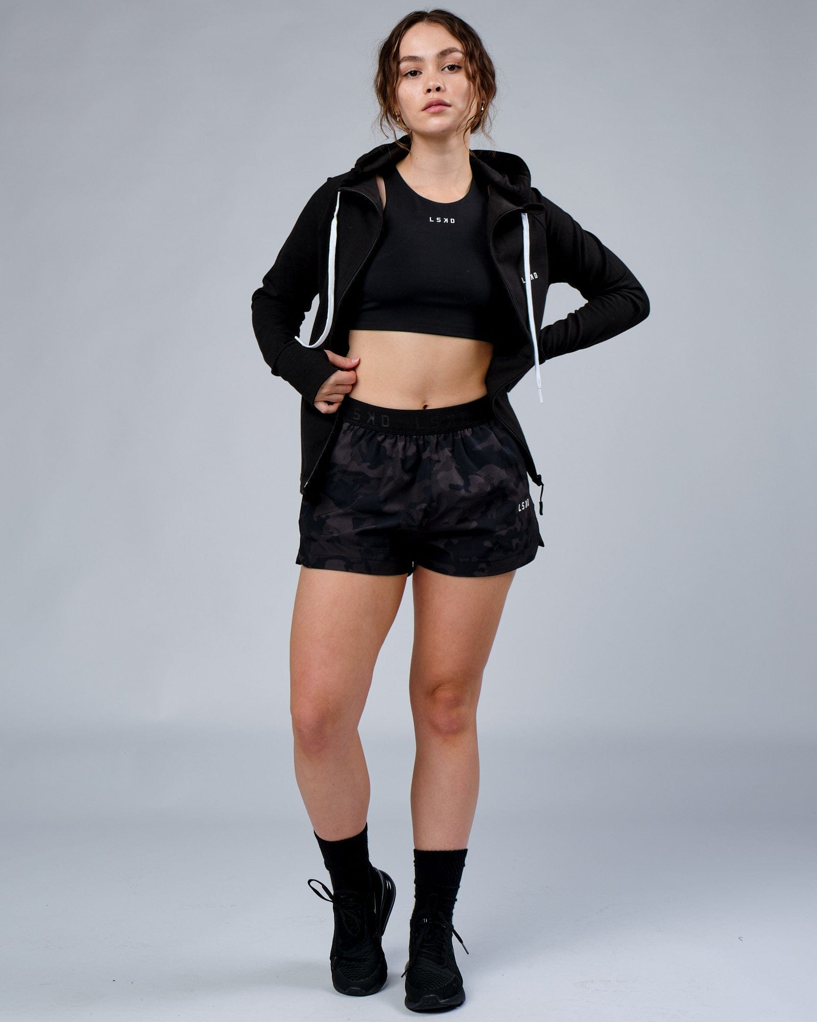 Model wearing Competition Performance Short - Black Camo