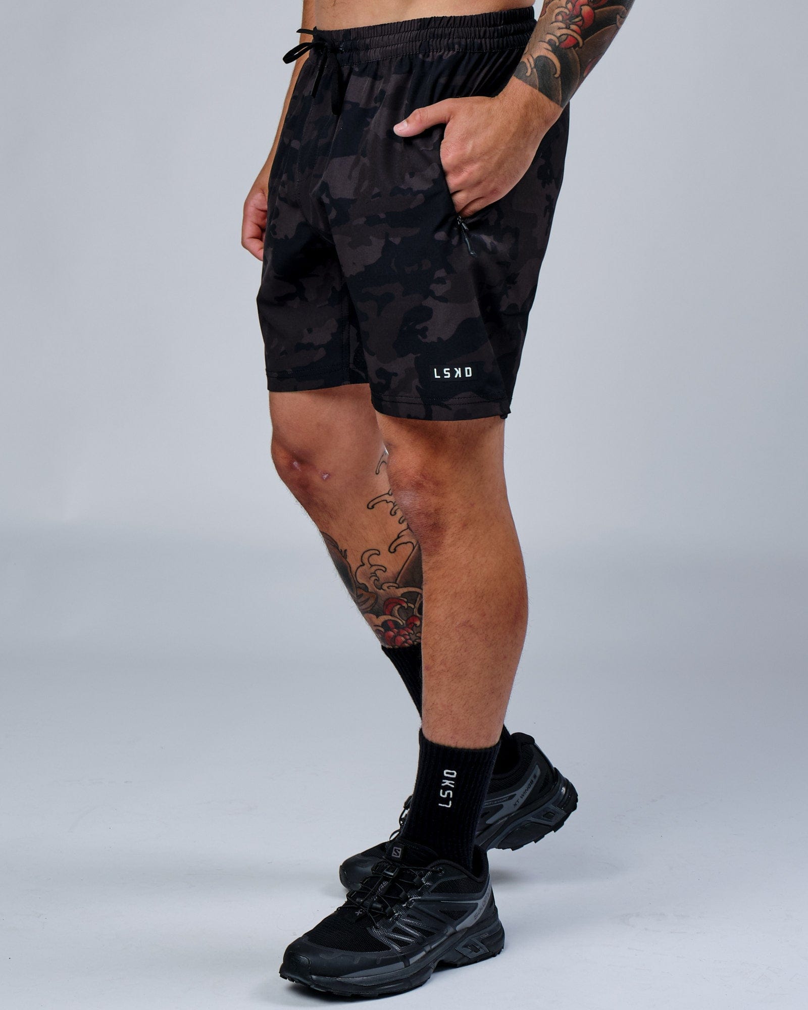 Model wearing Rep 7" Performance Short - Black Camo