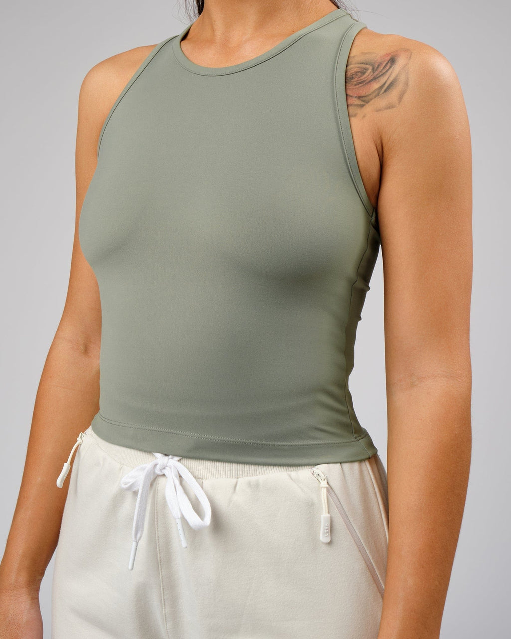 Model wearing Flow Performance Tank - Dusty Olive