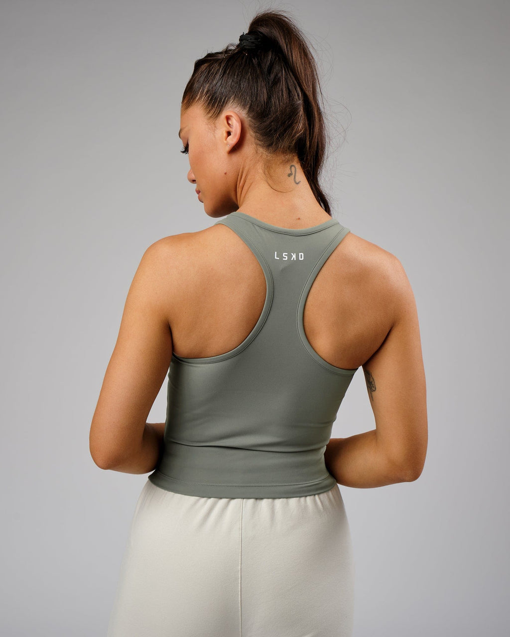 Model wearing Flow Performance Tank - Dusty Olive