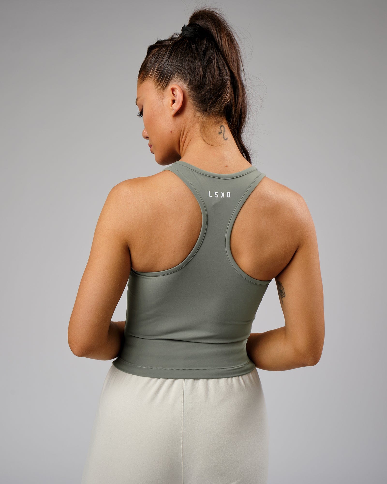 Model wearing Flow Performance Tank - Dusty Olive