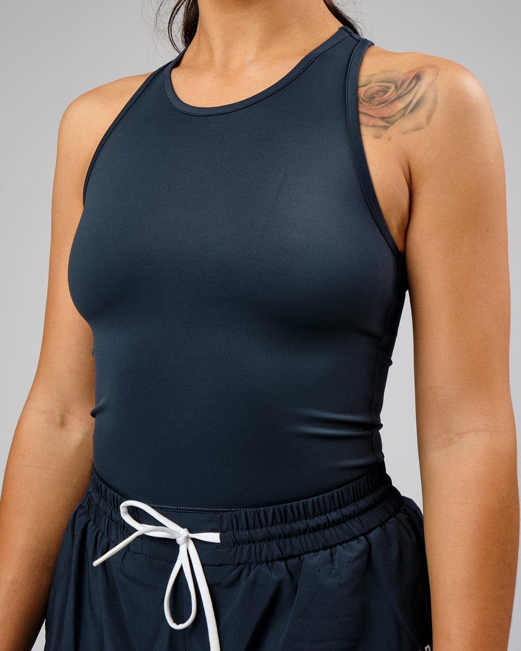 Model wearing Flow Performance Tank - Carbon