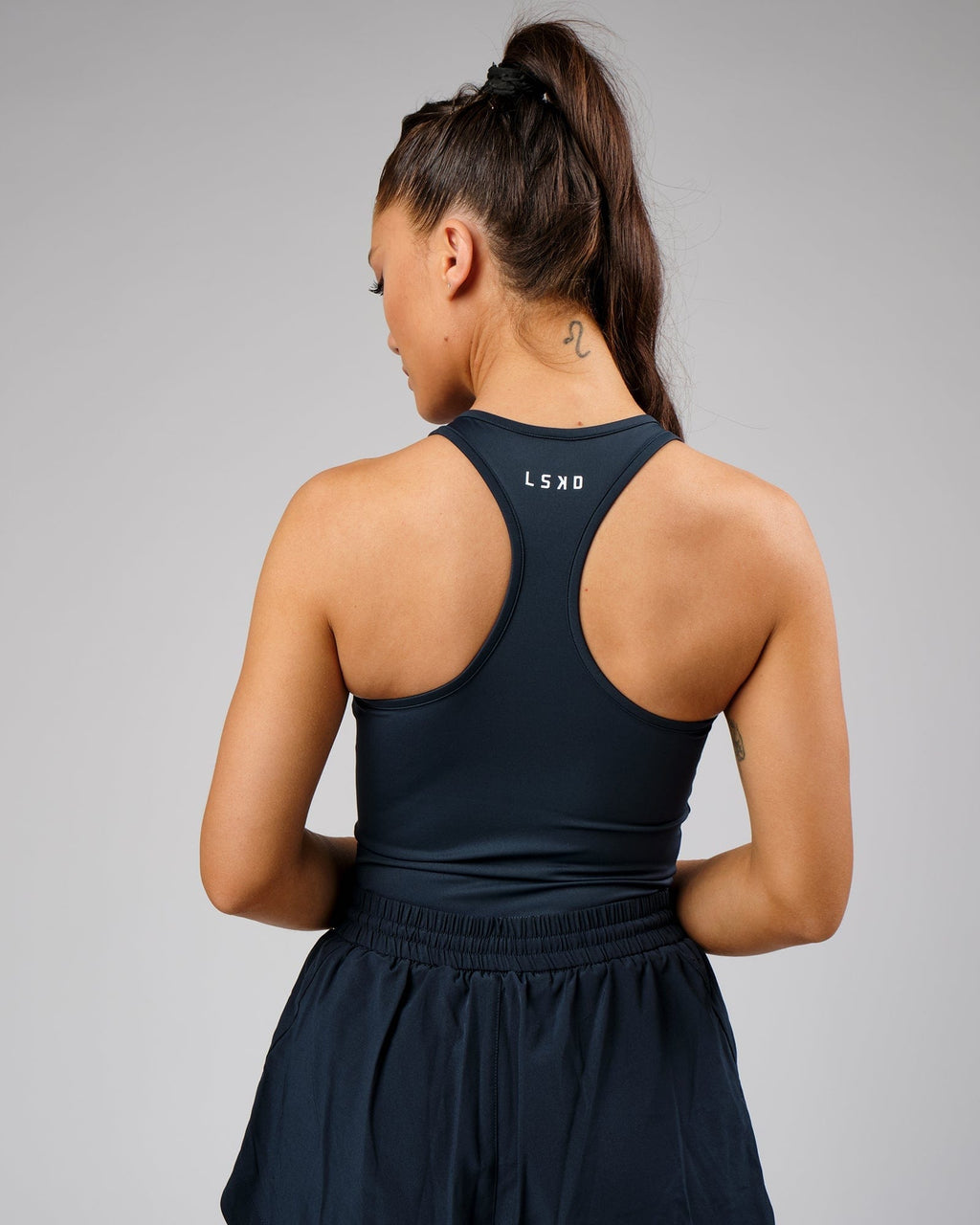 Model wearing Flow Performance Tank - Carbon