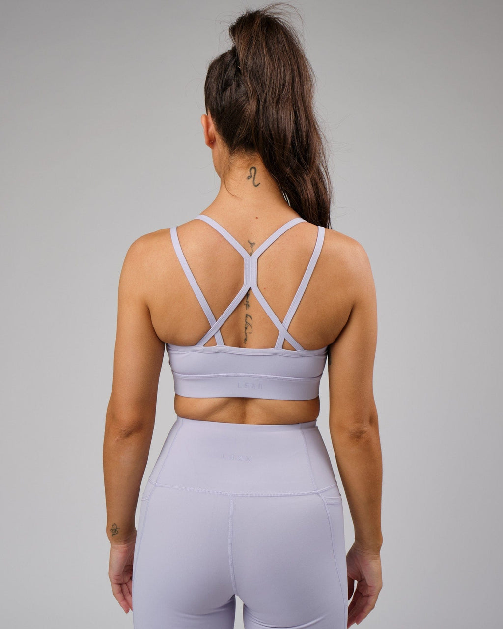 Model wearing Bridge Recycled Sports Bra - Cosmic Sky
