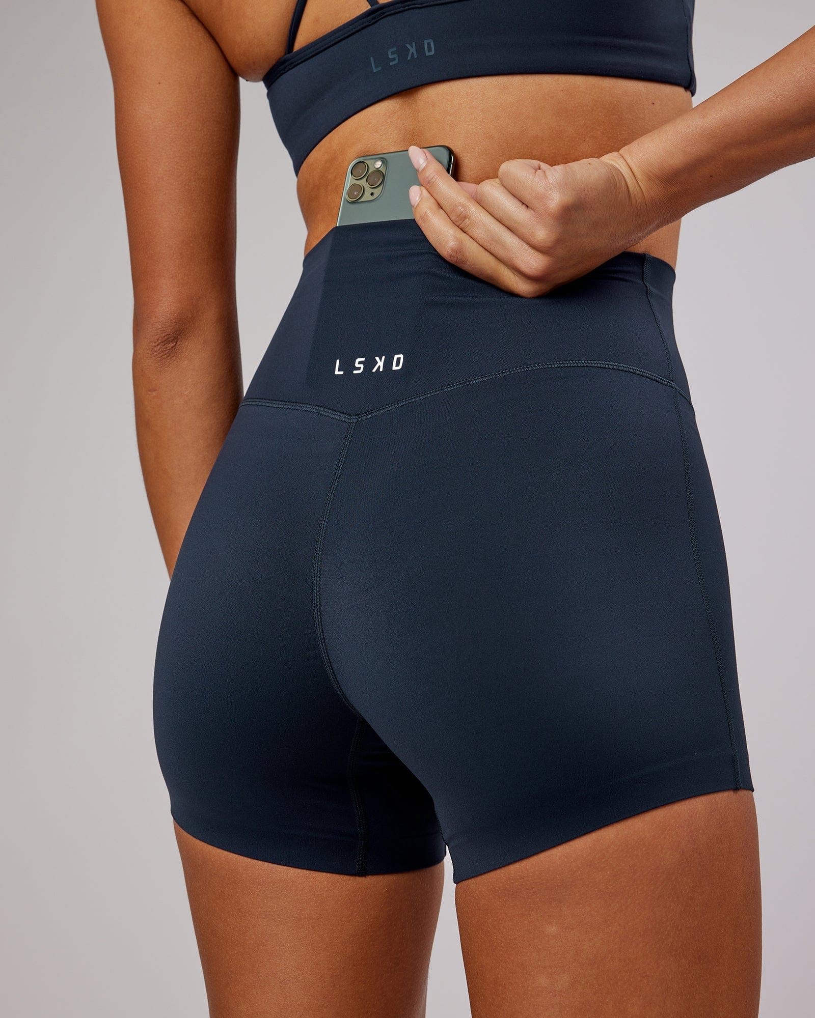 Model wearing Elixir X-Short Tight - Navy No Logo