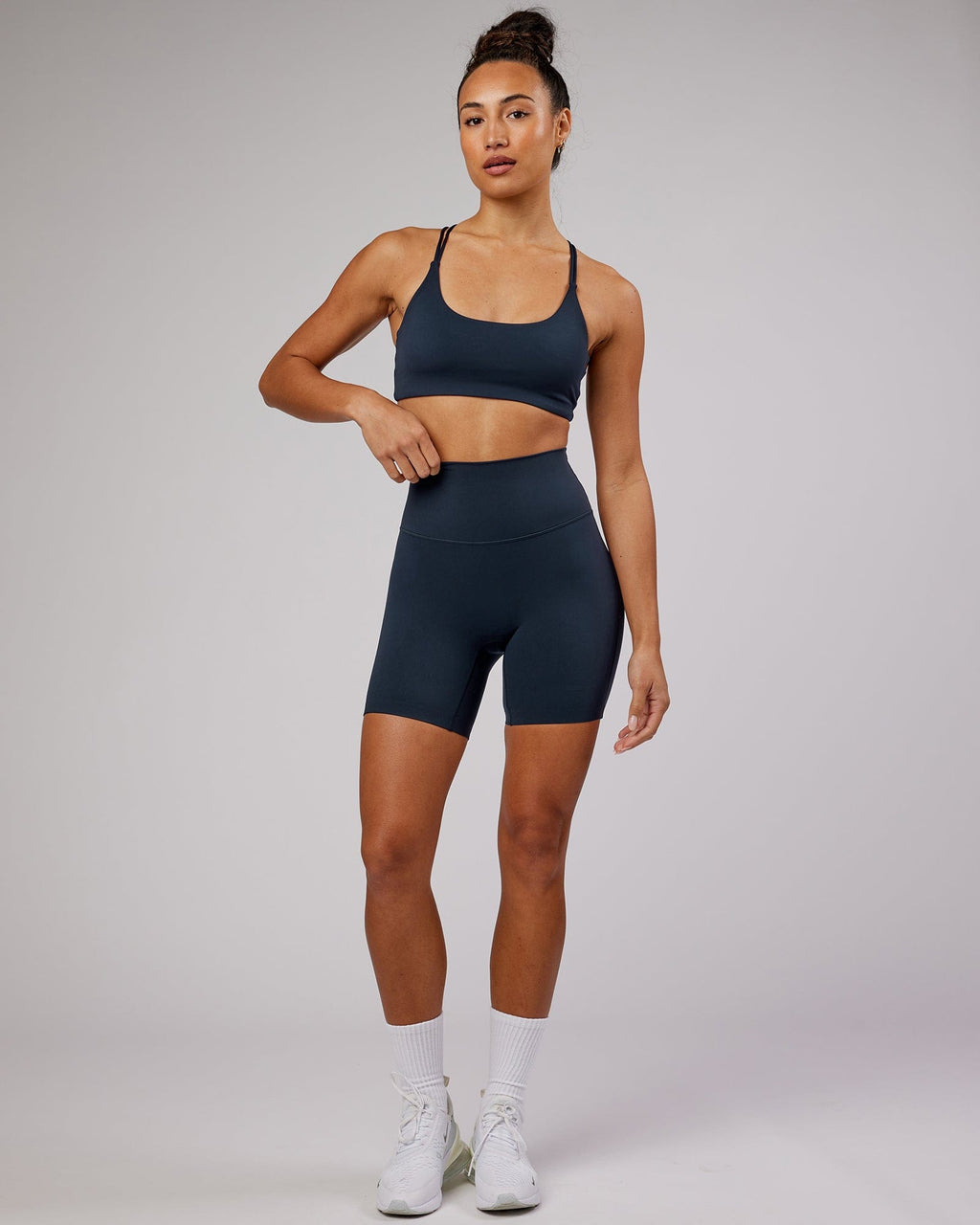 Model wearing Elixir Mid Short Tight - Navy No Logo