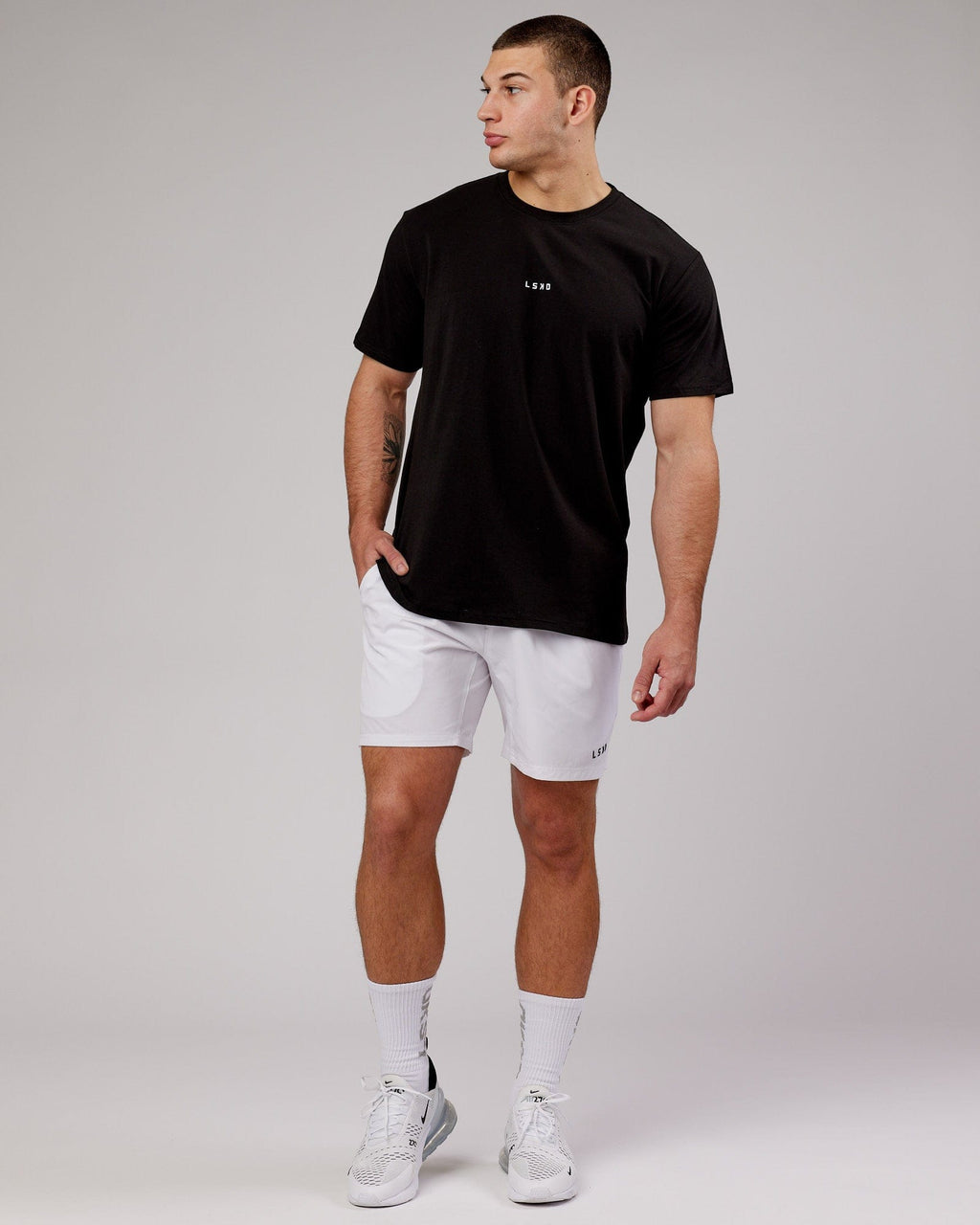 Model wearing Intensity 7" Performance Short - White