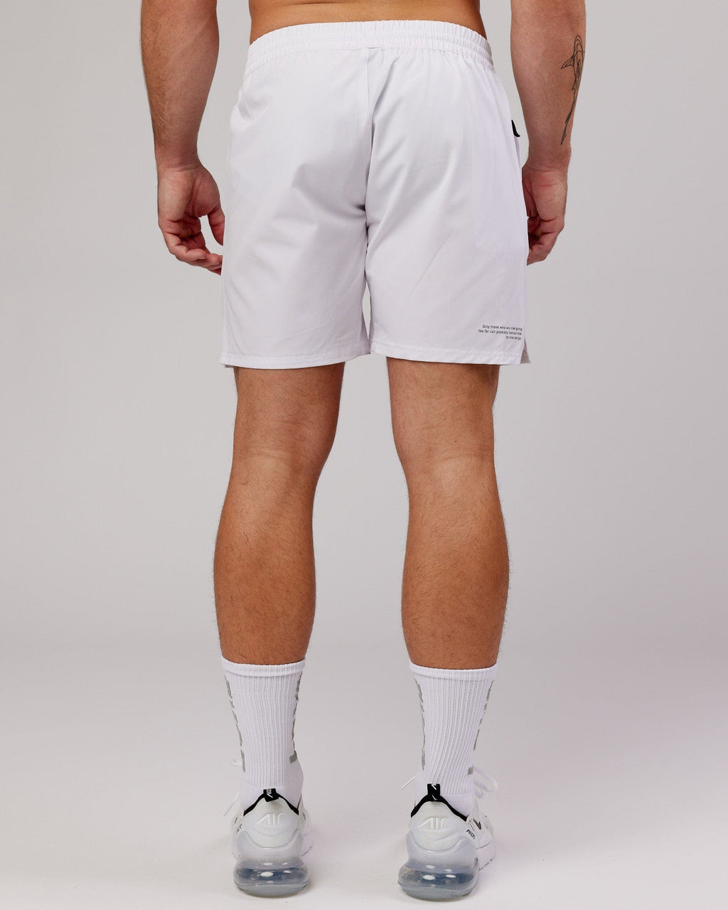 Model wearing Intensity 7" Performance Short - White