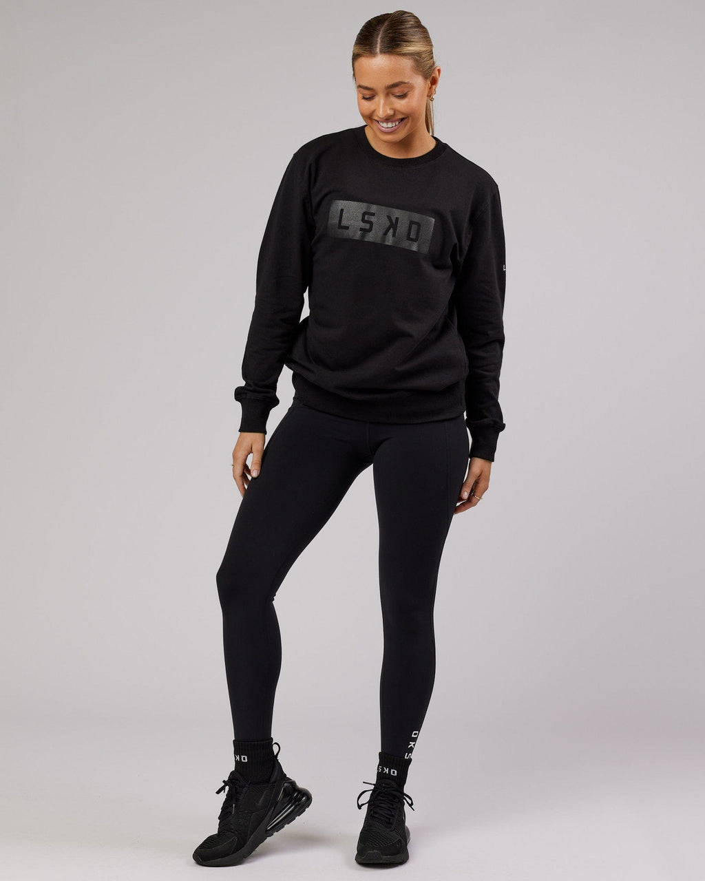 Model wearing Unisex Strength FLXFleece Training Fit Sweater - Black