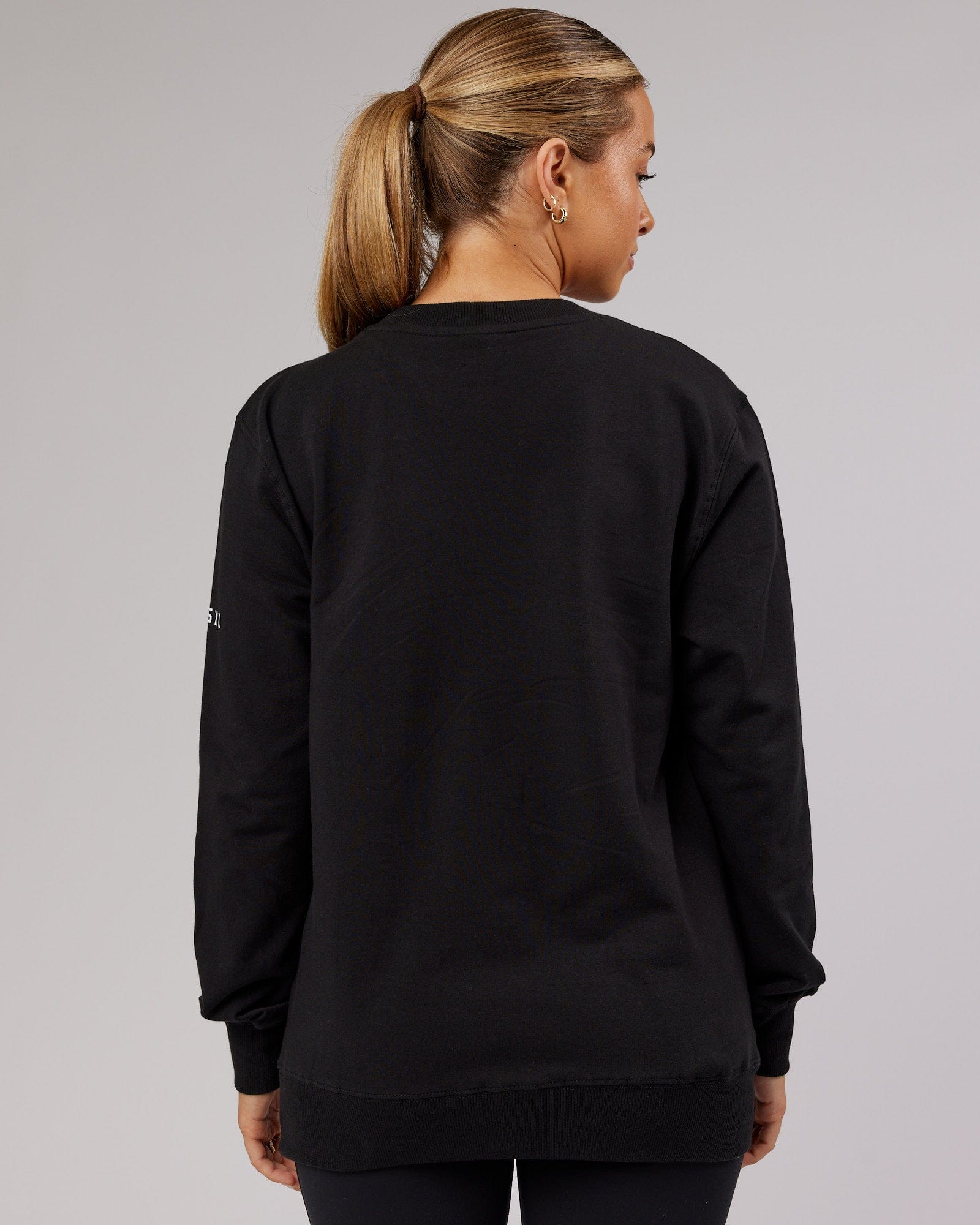 Model wearing Unisex Strength FLXFleece Training Fit Sweater - Black