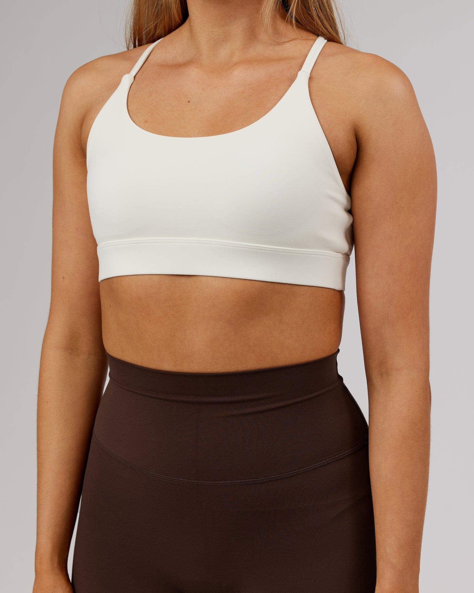Model wearing Elixir Sports Bra - Cream