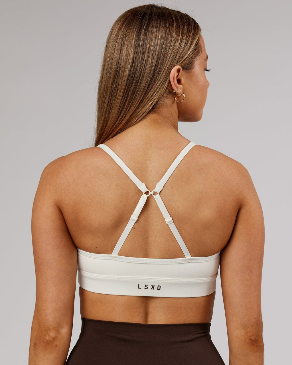 Model wearing Elixir Sports Bra - Cream