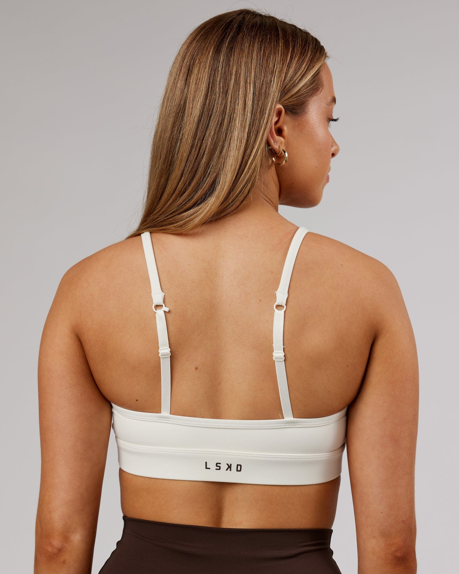 Model wearing Elixir Sports Bra - Cream