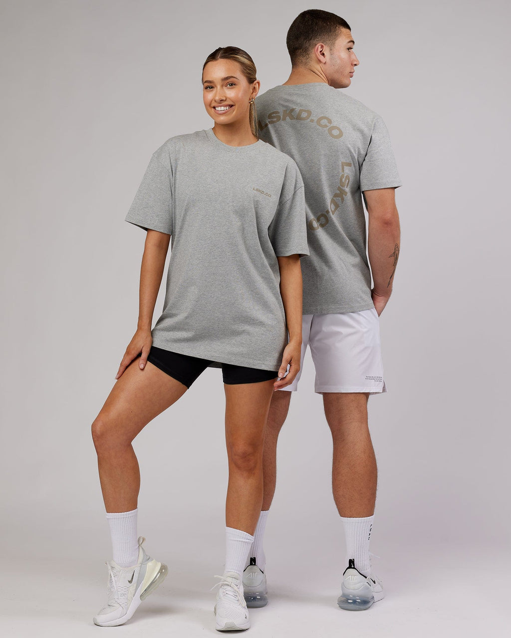 Model wearing Unisex Revolution Heavyweight Tee Oversize - Lt Grey Marl