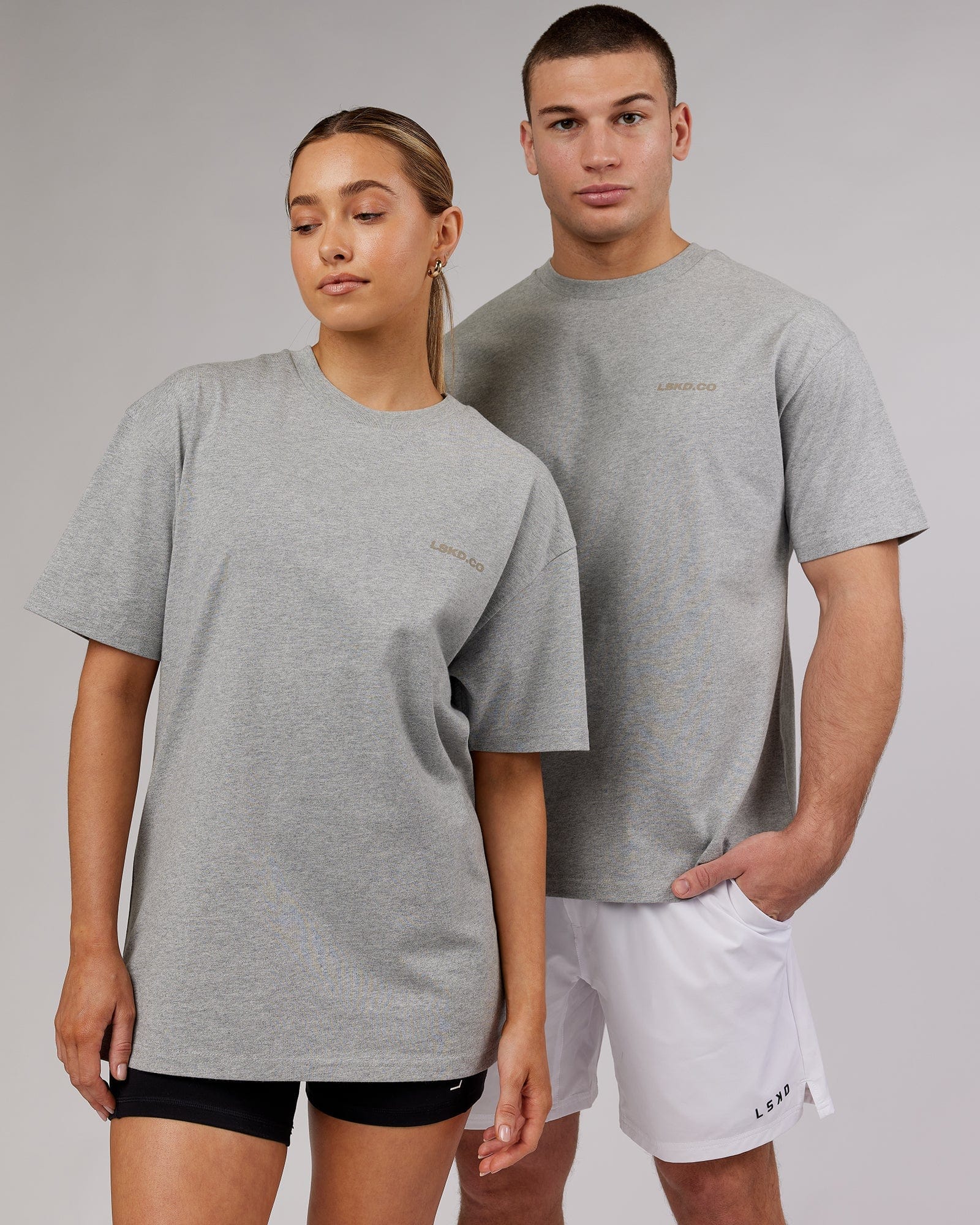 Model wearing Unisex Revolution Heavyweight Tee Oversize - Lt Grey Marl