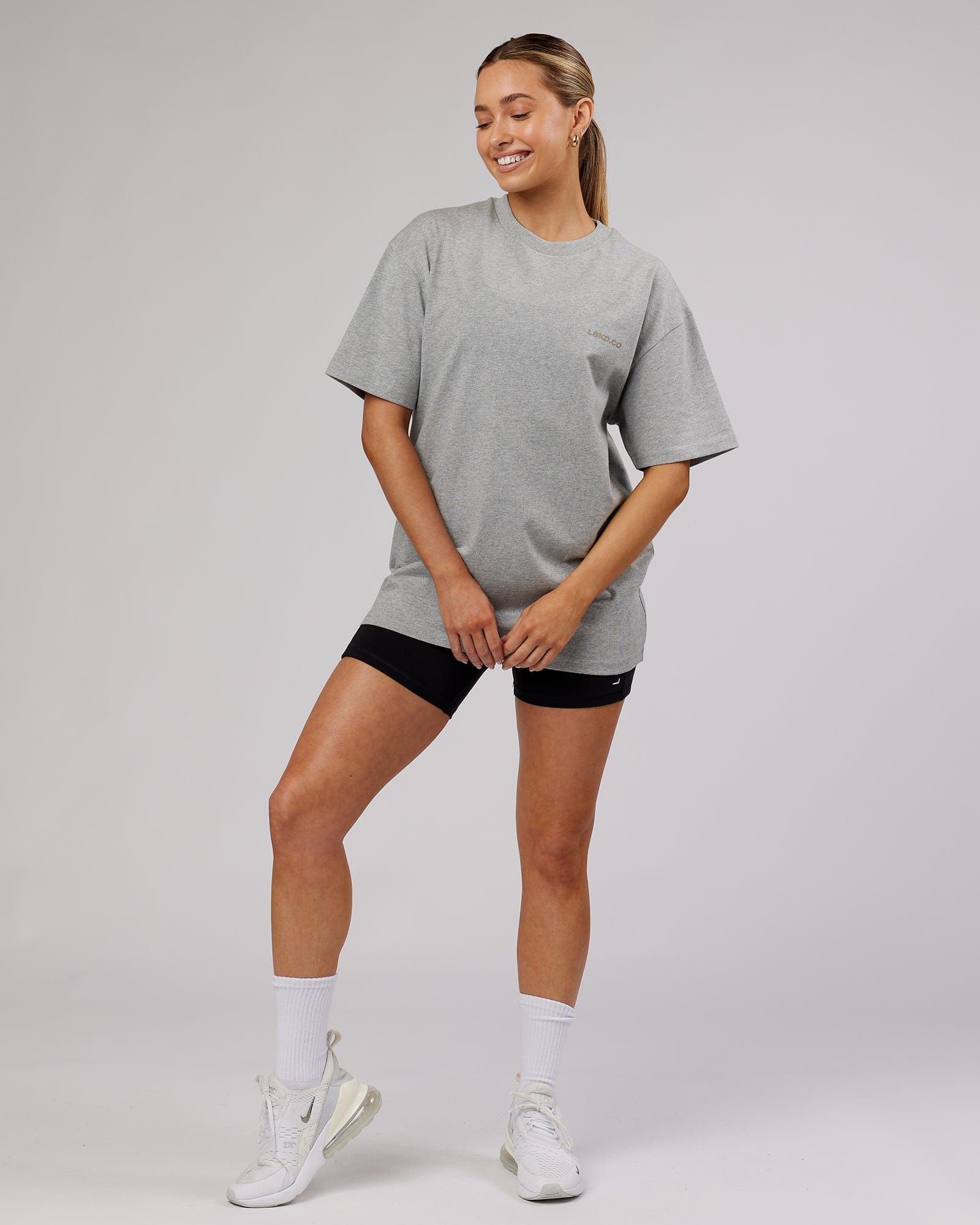 Model wearing Unisex Revolution Heavyweight Tee Oversize - Lt Grey Marl