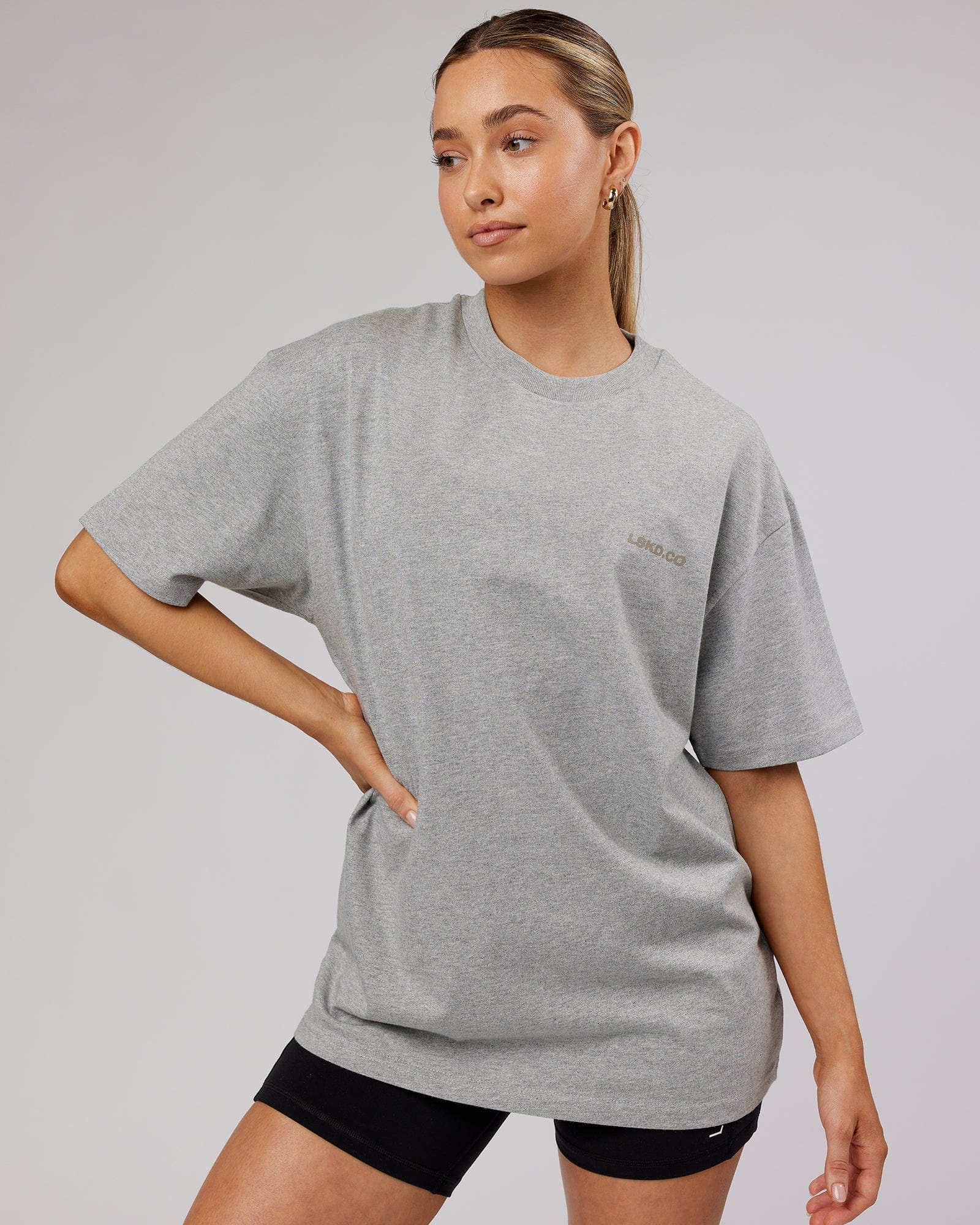 Model wearing Unisex Revolution Heavyweight Tee Oversize - Lt Grey Marl