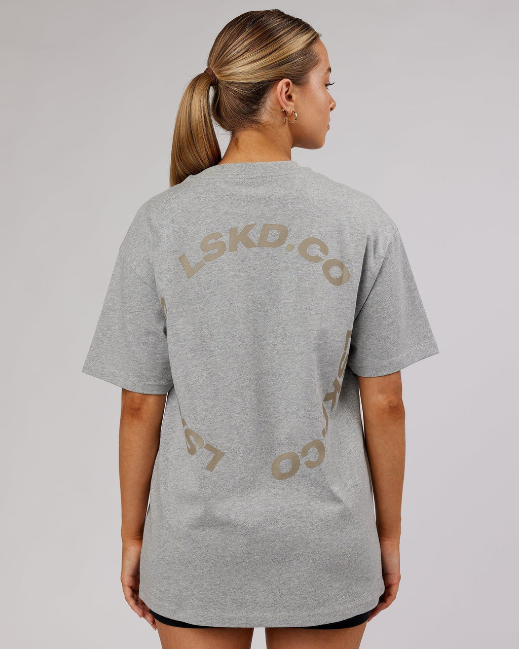 Model wearing Unisex Revolution Heavyweight Tee Oversize - Lt Grey Marl