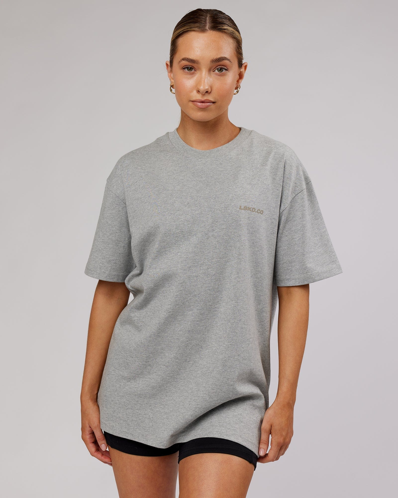 Model wearing Unisex Revolution Heavyweight Tee Oversize - Lt Grey Marl