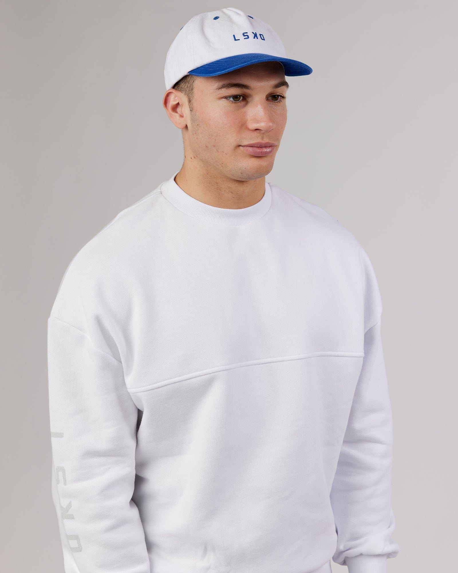 Model wearing Slouch Vintage Fit Cap - White-Cobalt