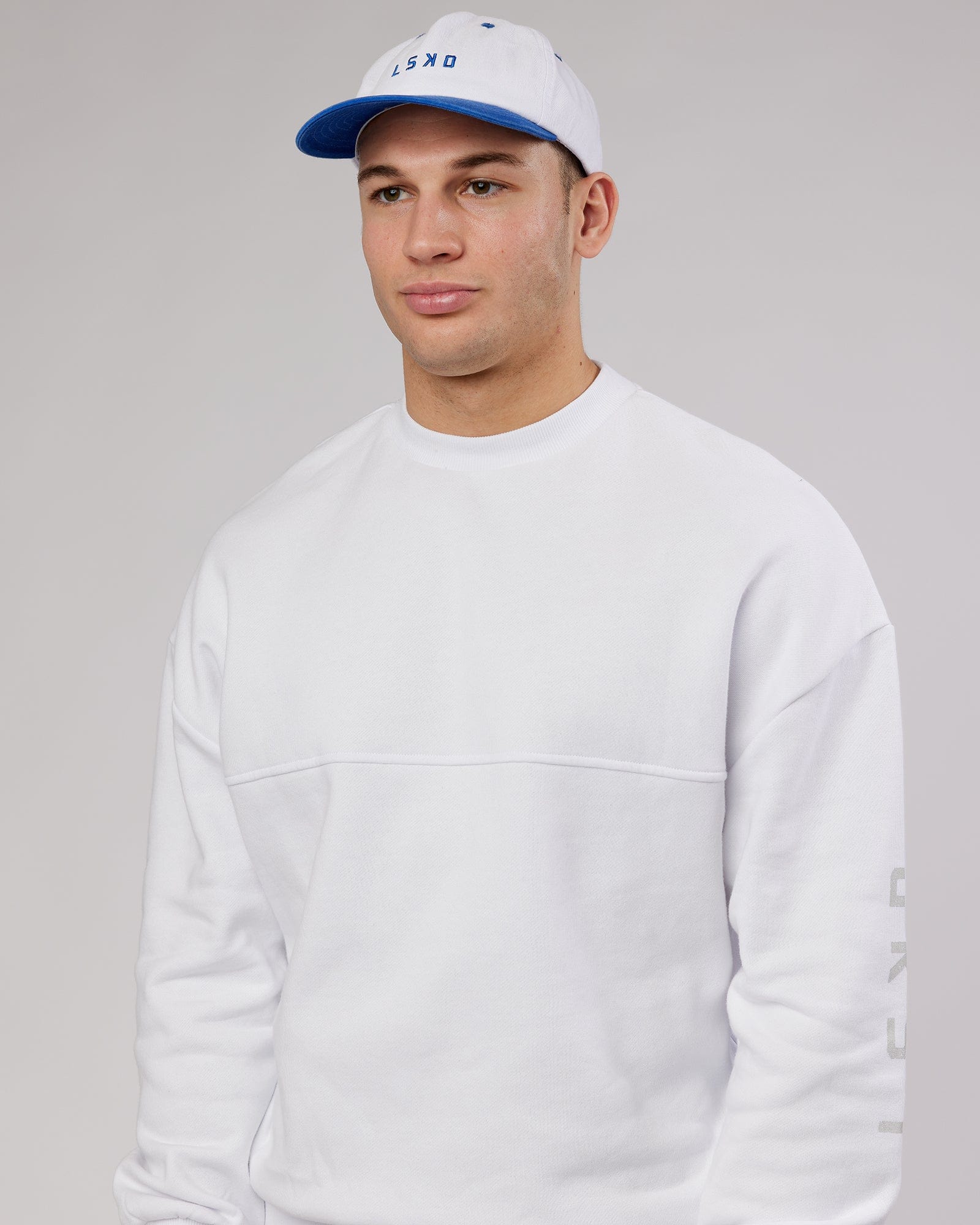 Model wearing Slouch Vintage Fit Cap - White-Cobalt