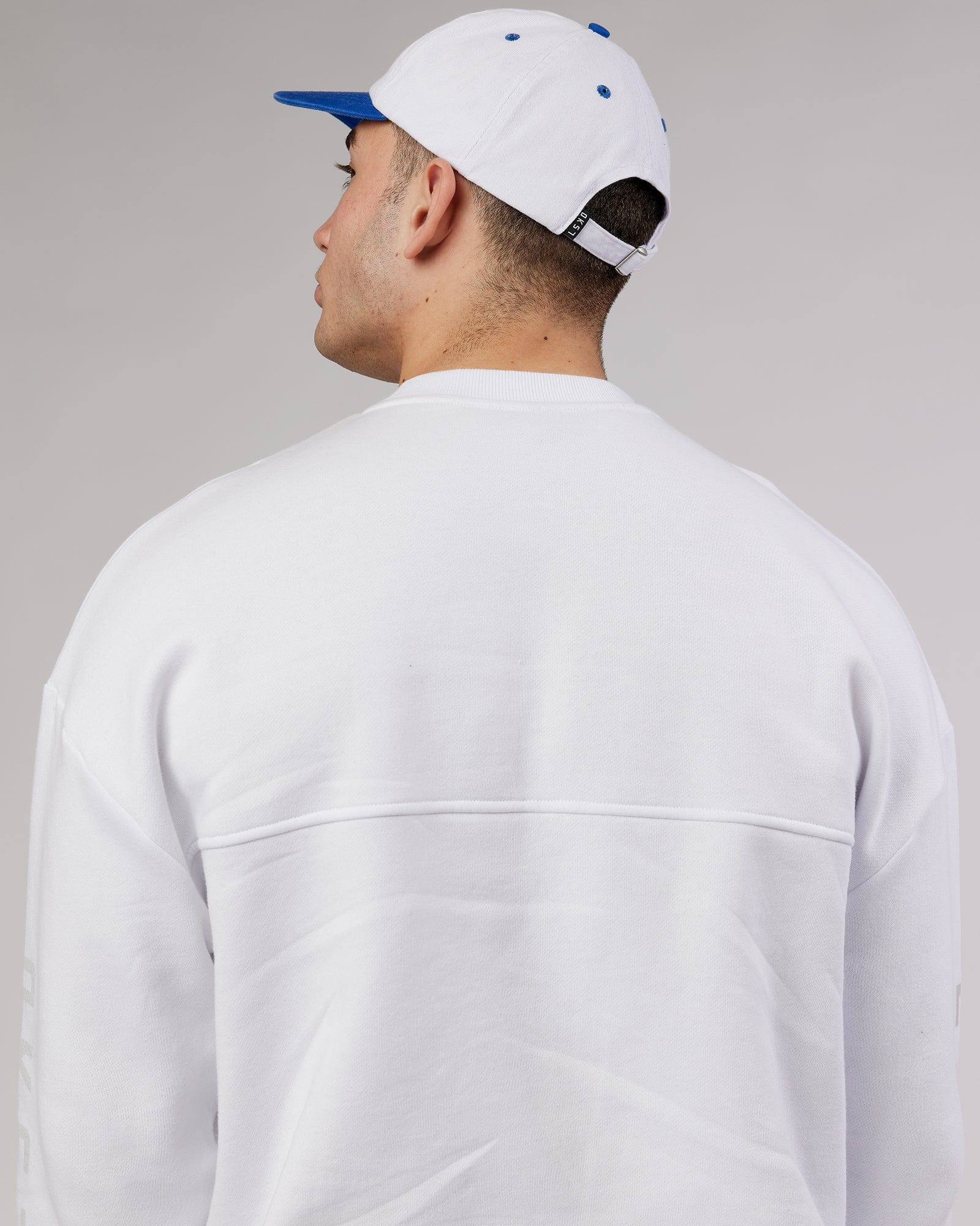 Model wearing Slouch Vintage Fit Cap - White-Cobalt