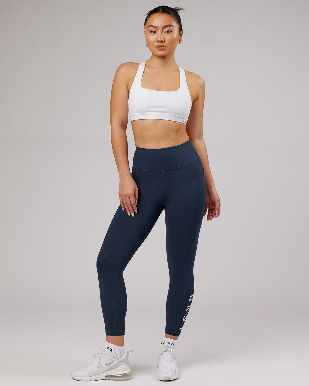 Model wearing Rep 7/8 Length Tight - Navy